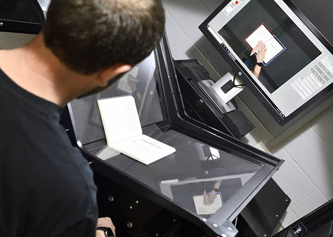 tech scanning a book