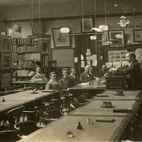 black and white photo of people working in the library