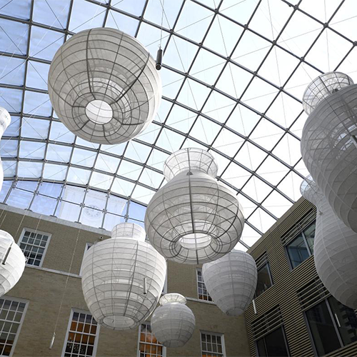 large sculptural forms hanging from glass ceiling