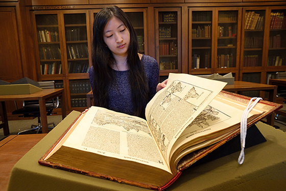 a student looking at an old book